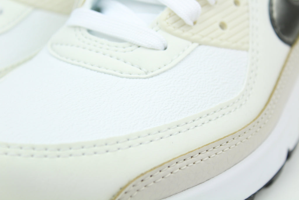 Nike Air Max 90 (Women's) sneakers in 'White & Flat Pewter' colorway, stylish and comfortable women's athletic shoes with white and pewter accents, perfect for casual and sporty wear.