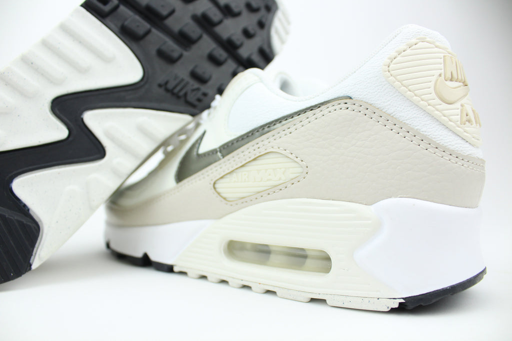 Nike Air Max 90 (Women's) sneakers in 'White & Flat Pewter' colorway, stylish and comfortable women's athletic shoes with white and pewter accents, perfect for casual and sporty wear.