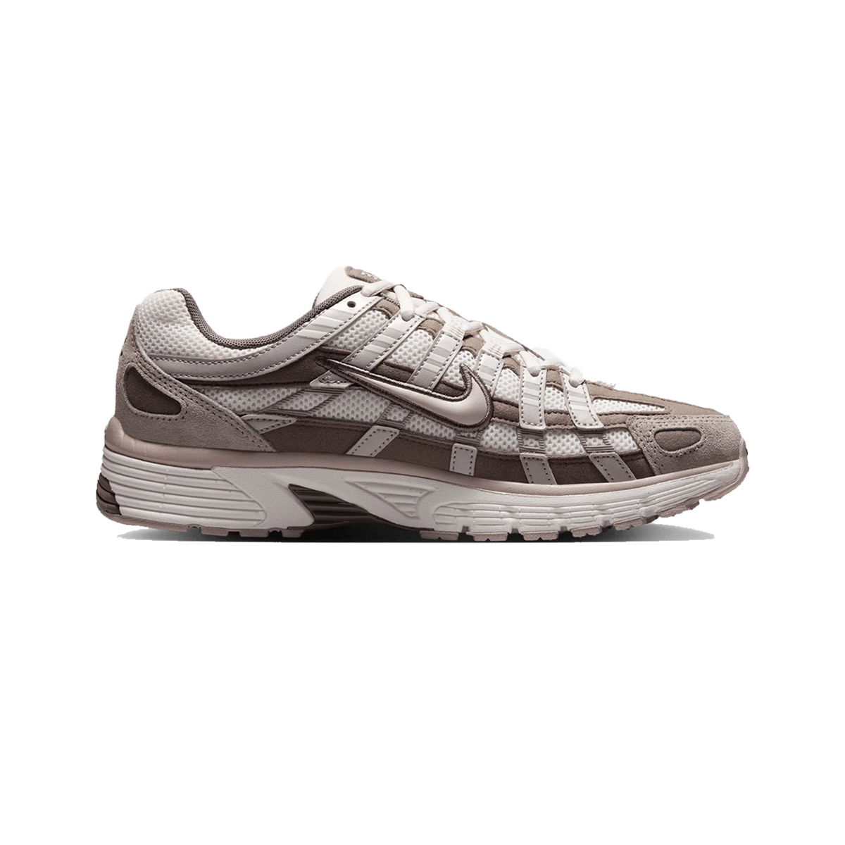 Side view of a Nike P-6000 sneaker in taupe and off-white tones with a caged lace overlay and chunky treaded sole.