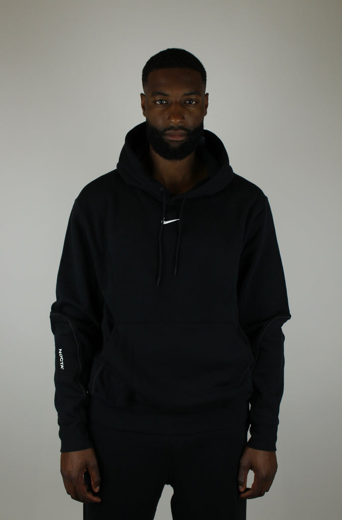 Nike x NOCTA Fleece CS Hoodie ‘Black’ – stylish black fleece hoodie featuring collaboration branding, soft and warm fabric, and a relaxed fit, perfect for streetwear and casual wear.