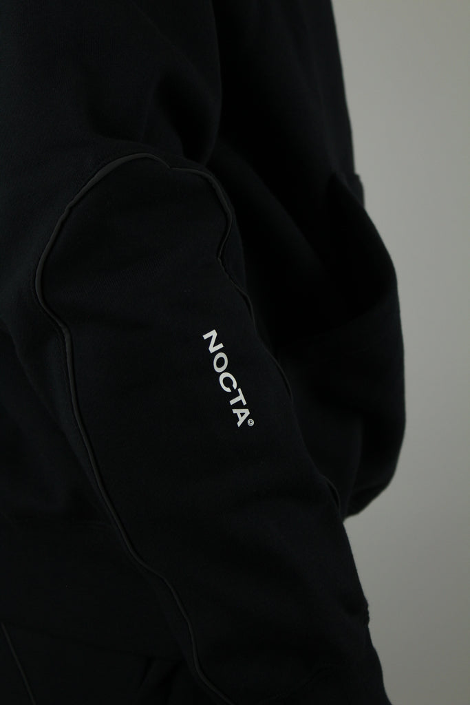 Nike x NOCTA Fleece CS Hoodie ‘Black’ – stylish black fleece hoodie featuring collaboration branding, soft and warm fabric, and a relaxed fit, perfect for streetwear and casual wear.