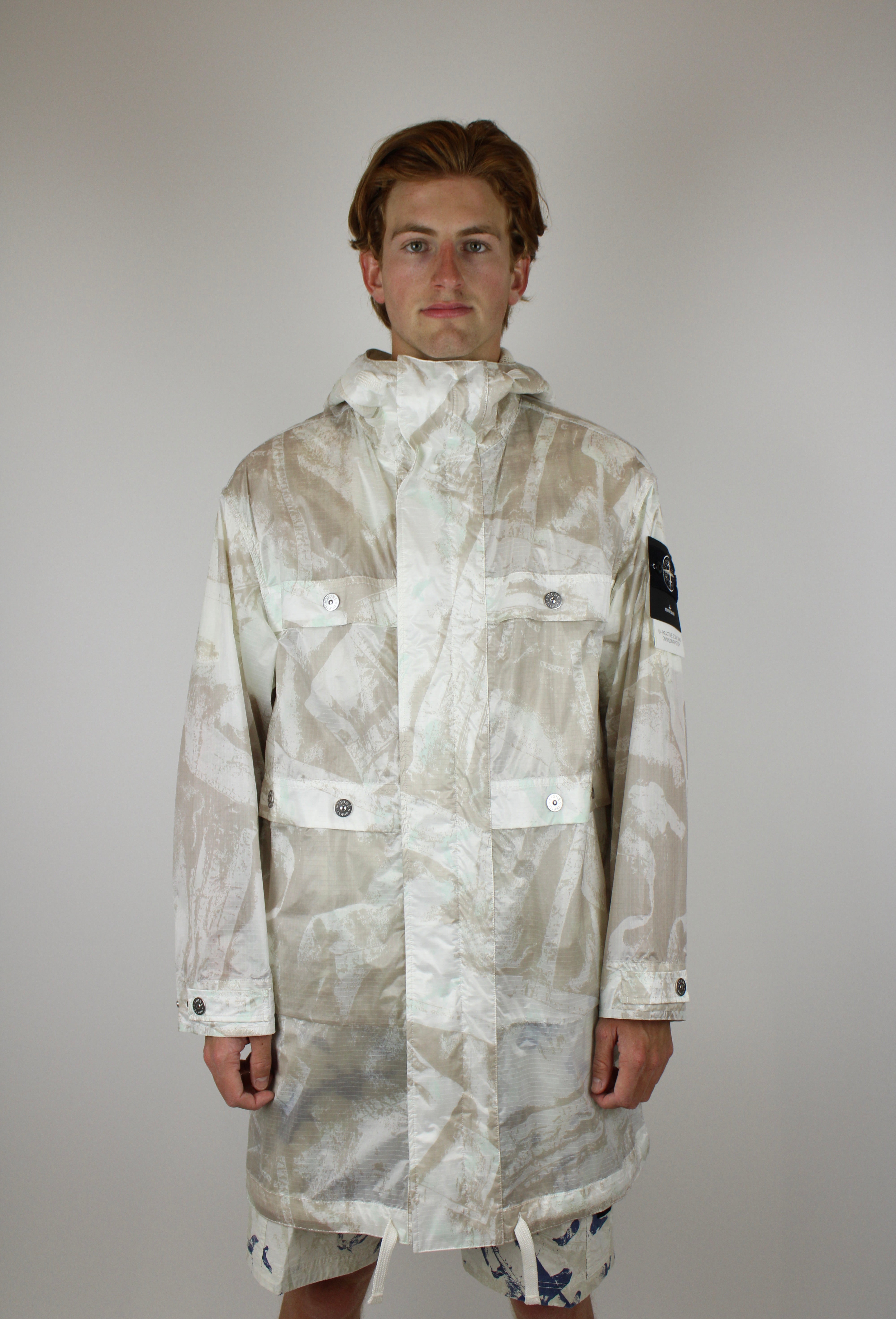 Stone Island UV-reactive Nylon Parka 'Camouflage Desert' – lightweight waterproof jacket with UV-sensitive camouflage pattern, functional design, and iconic logo, perfect for urban and outdoor style.
