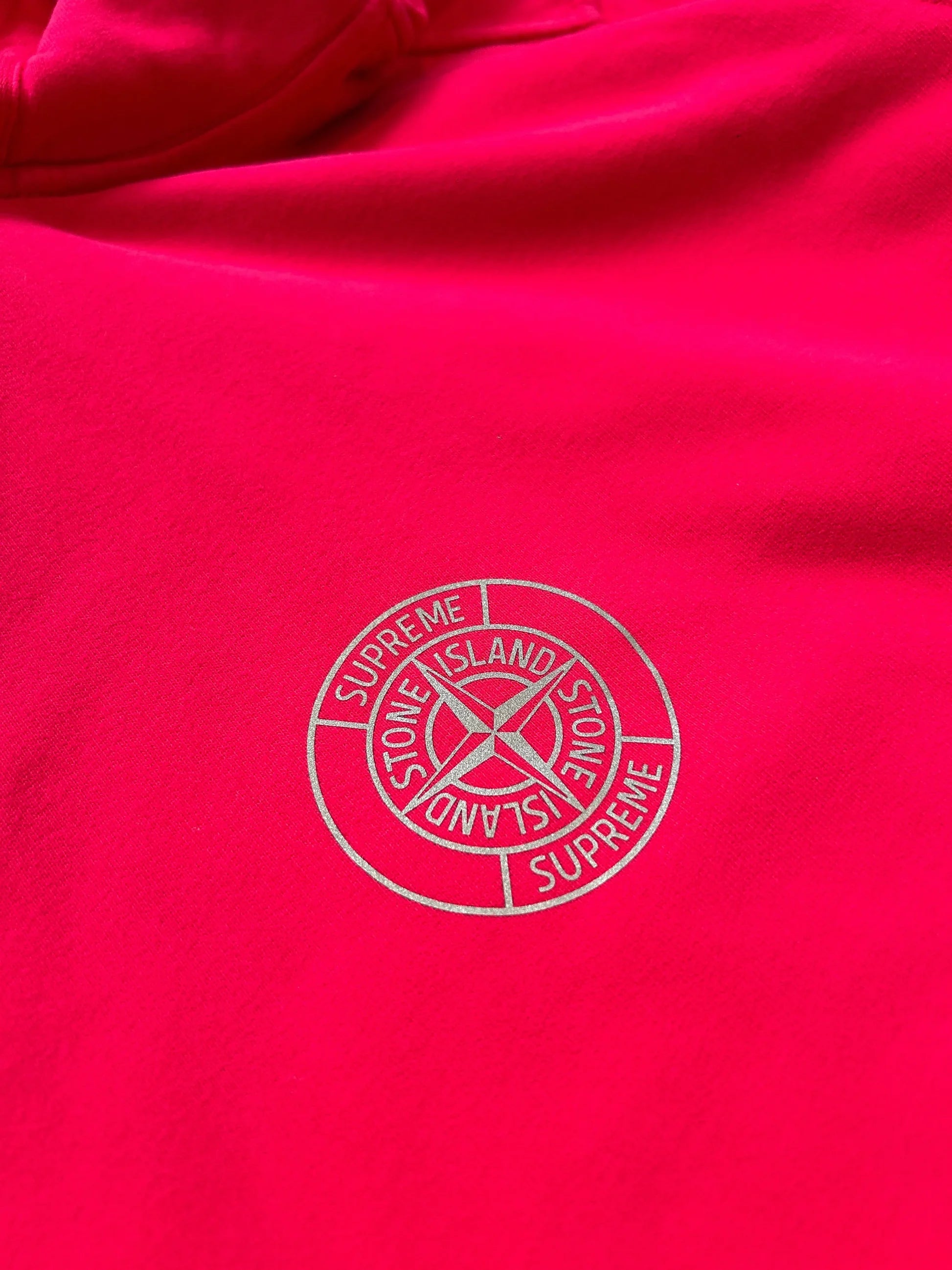 Supreme x Stone Island hooded sweatshirt in magenta from Fall Winter 2017 with compass badge detail.